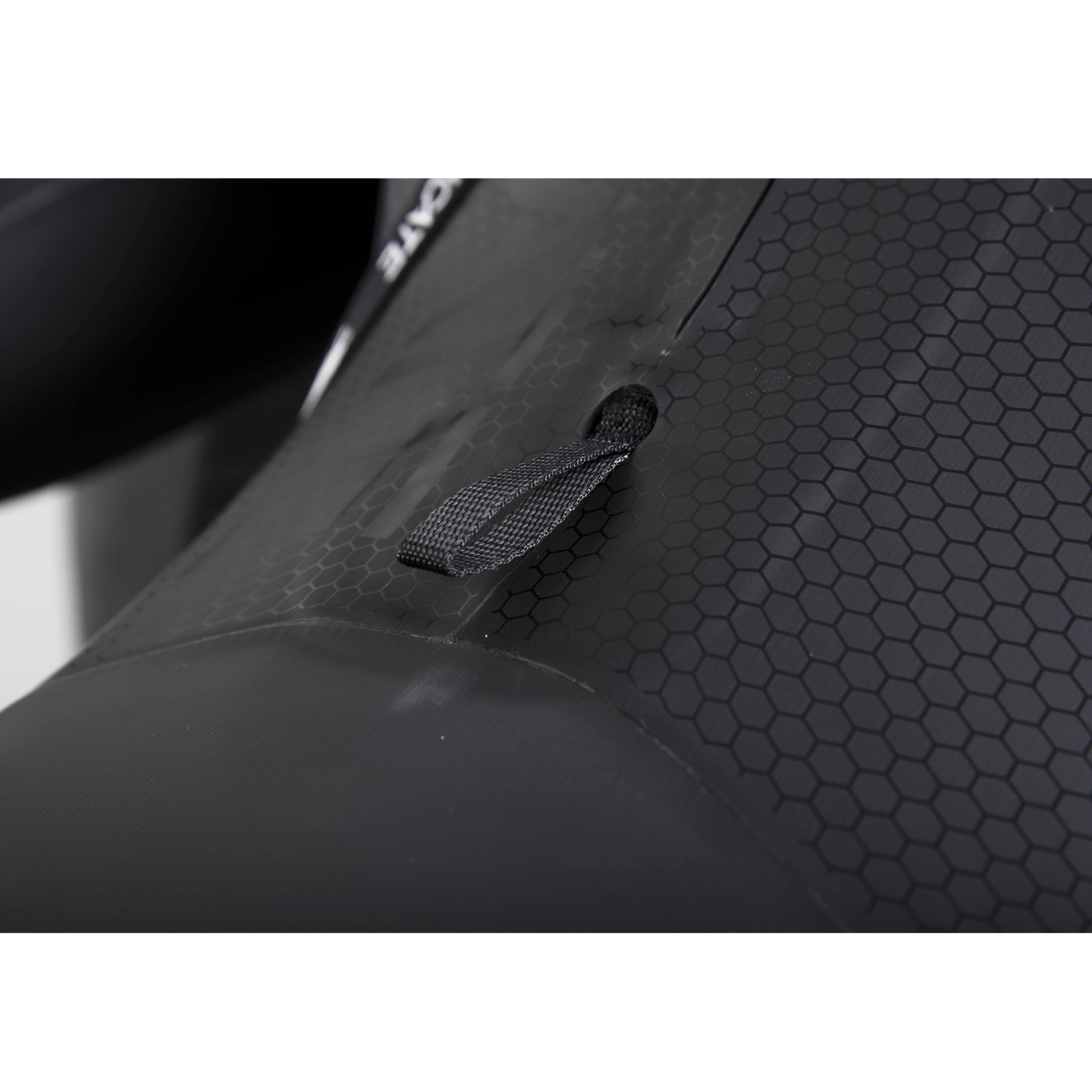 Close-up of the wetsuit’s hex-textured panel, featuring a reinforced pull tab for adjustments and added durability.