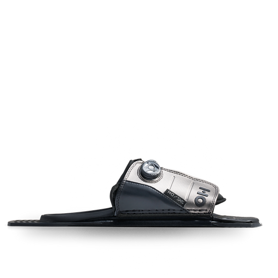Side view of a black and silver Stance ATOP adjustable rear toe plate with a dial closure.