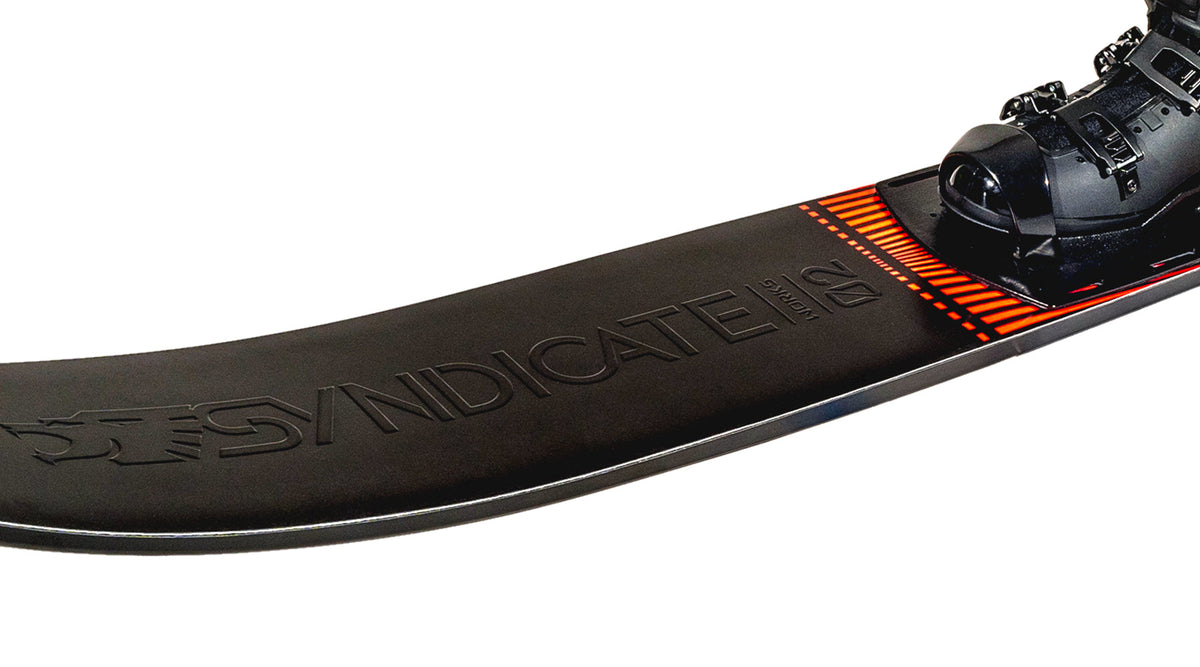 Close-up of a waterski with 'Syndicate' branding  and a black water ski binding on a white background