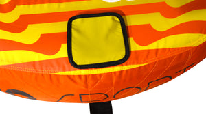 Close-up view of 2G Tube yellow square patch on striped orange and yellow fabric.