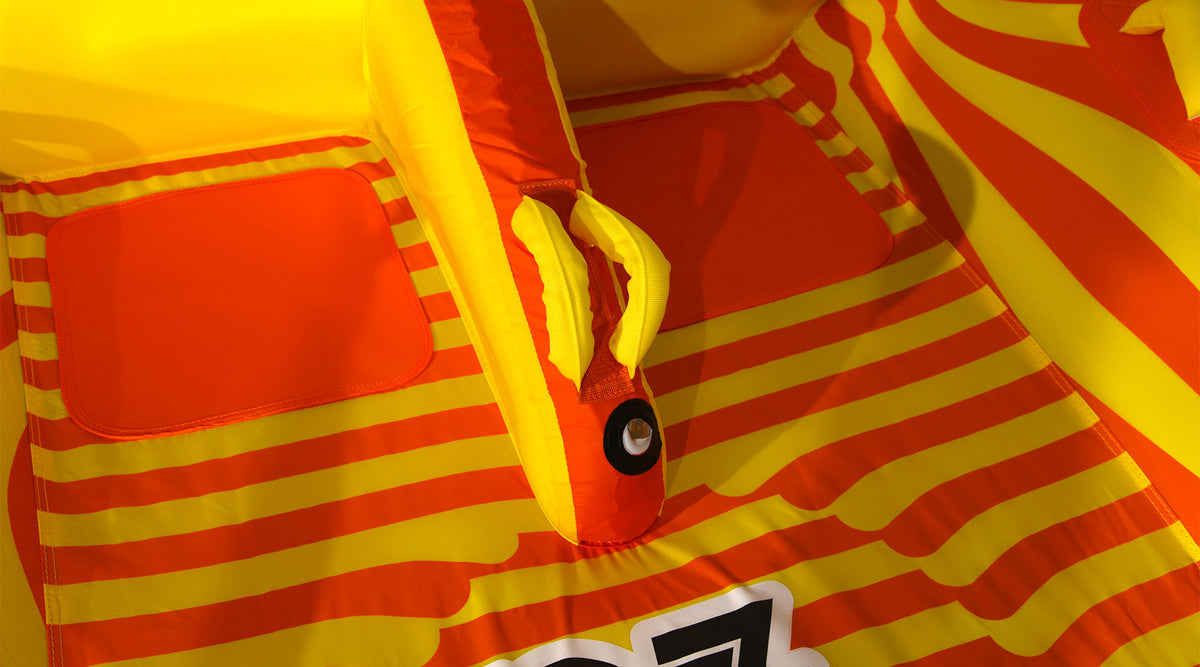 Close-up of the 2G Tube's center foam grab handle and knuckle guard on the striped deck.
