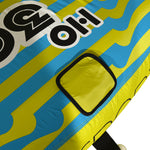 Close-up view of 3G Tube yellow square patch on striped blue and yellow fabric.