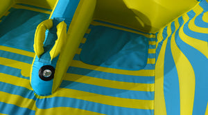 Close-up of a padded grab handle, inflation valve, and teal seat panel on the striped deck.