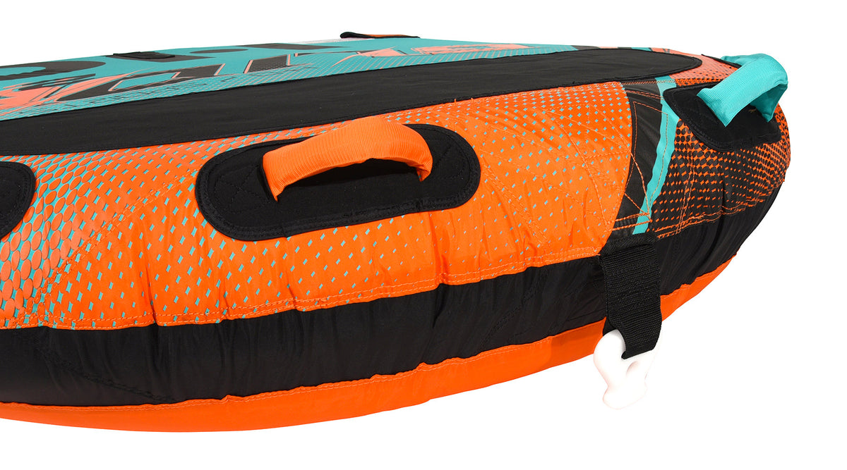 Close-up of orange and teal grab handles on the orange halftone-dotted tube.