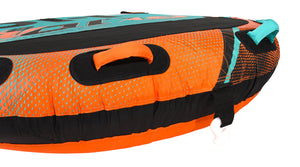 Close-up of orange and teal grab handles on the orange halftone-dotted tube.
