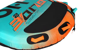 Close-up of the black center pad and orange grab handles on the teal and orange dotted deck.