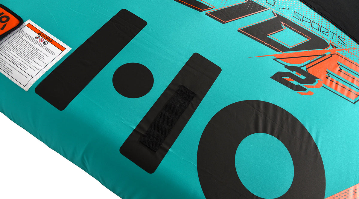 Close-up of the black HO graphic beside a warning label on the teal deck.