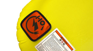 Close-up of an orange HO logo patch and warning label on the yellow fabric.