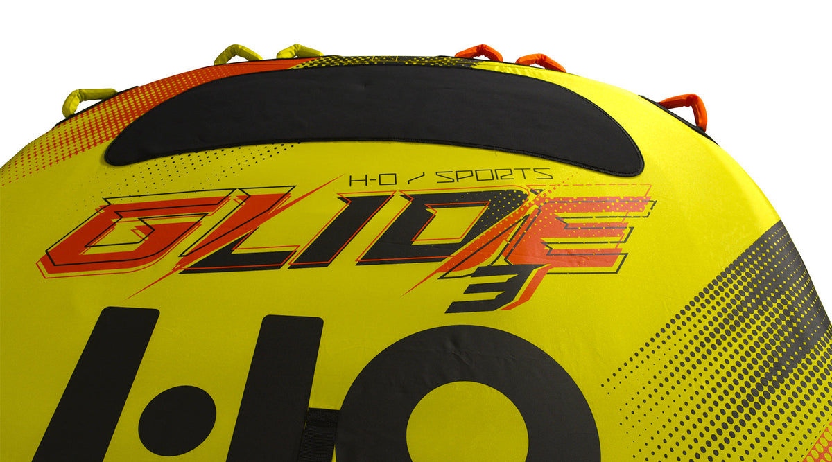 Close-up of the Glide 3 logo and black center pad beside yellow and orange grab handles.