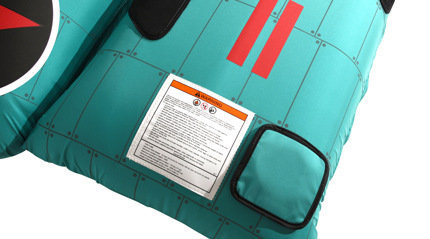 Close-up view of Tomcat Tube corner with warning label on teal surface.