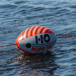 Inflated Rope Doctor towing device floating on water with red rope attached.
