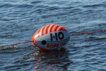 Inflated Rope Doctor towing device floating on water with red rope attached.
