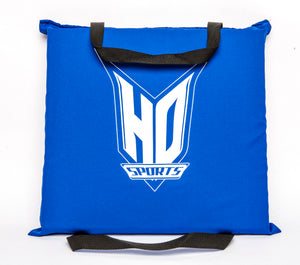 Top view of the Seat Cushion PFD, blue with a large white HO Sports logo and black grab straps on two sides.