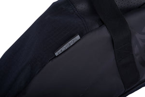 Close-up of the Universal Slalom Bag's grey HO Skis label near the webbing carry handle.