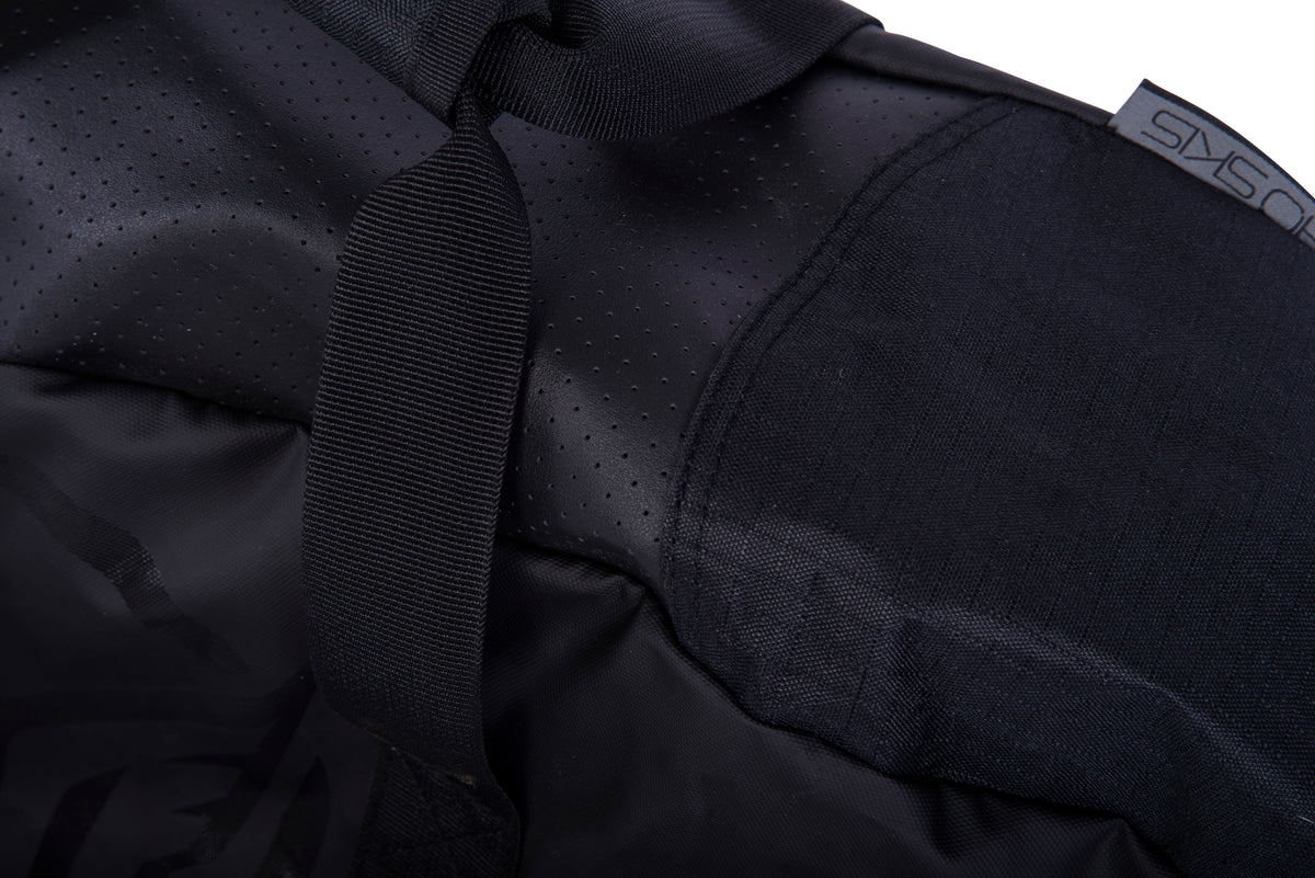 Close-up of the Hovercraft Bag's perforated panel, webbing carry handle and grey HO Skis tab.