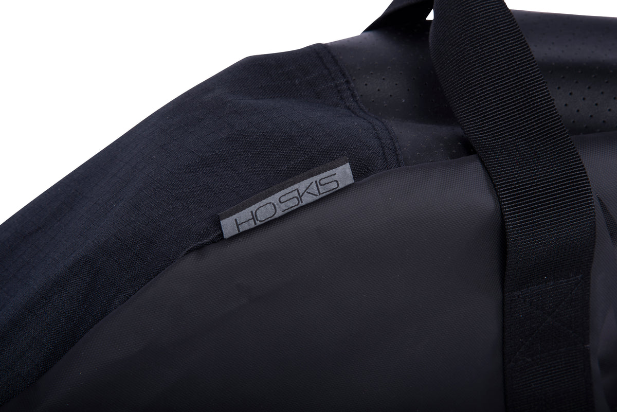 Close-up of the Hovercraft Bag's grey HO Skis label near the webbing carry handle.