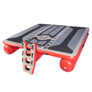 Angled view of the inflatable Hawaii Tritoon platform in grey and red with a black traction surface and ladder attachment.