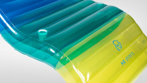 Angled view of Chaise Multi-Lounger's blue to yellow-green gradient surface with cup holder and HO Sports logo.