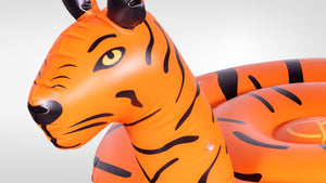 Close-up of Tiger Float's inflatable orange and black tiger head with illustrated face detail.