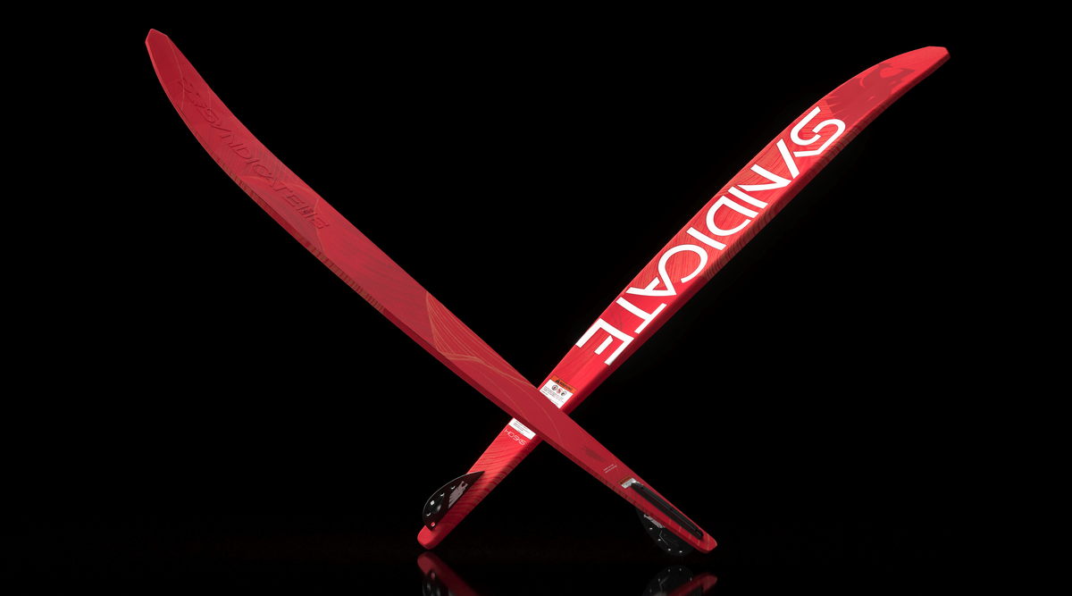 Angled view of two red Syndicate Works 01 slalom water skis crossed over each other.
