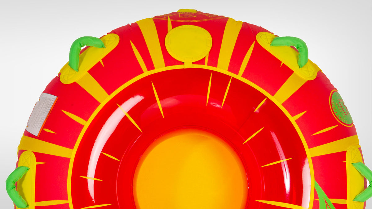 Top-down view of Citrus Tube showing red and yellow citrus print, green handles, and open center.