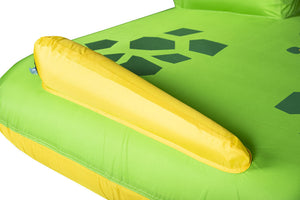 Close-up of Dino Tube's green surface with dark hex print and yellow inflatable tail fin bumper.