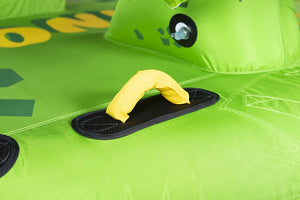 Close-up of Dino Tube's green surface with yellow padded handle, black grip pad, and dinosaur head detail.