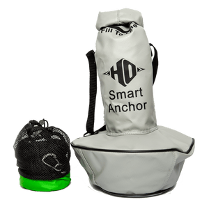Front view of the HO Smart Anchor, a gray portable anchor bag with black straps, a mesh storage pouch, and green base.