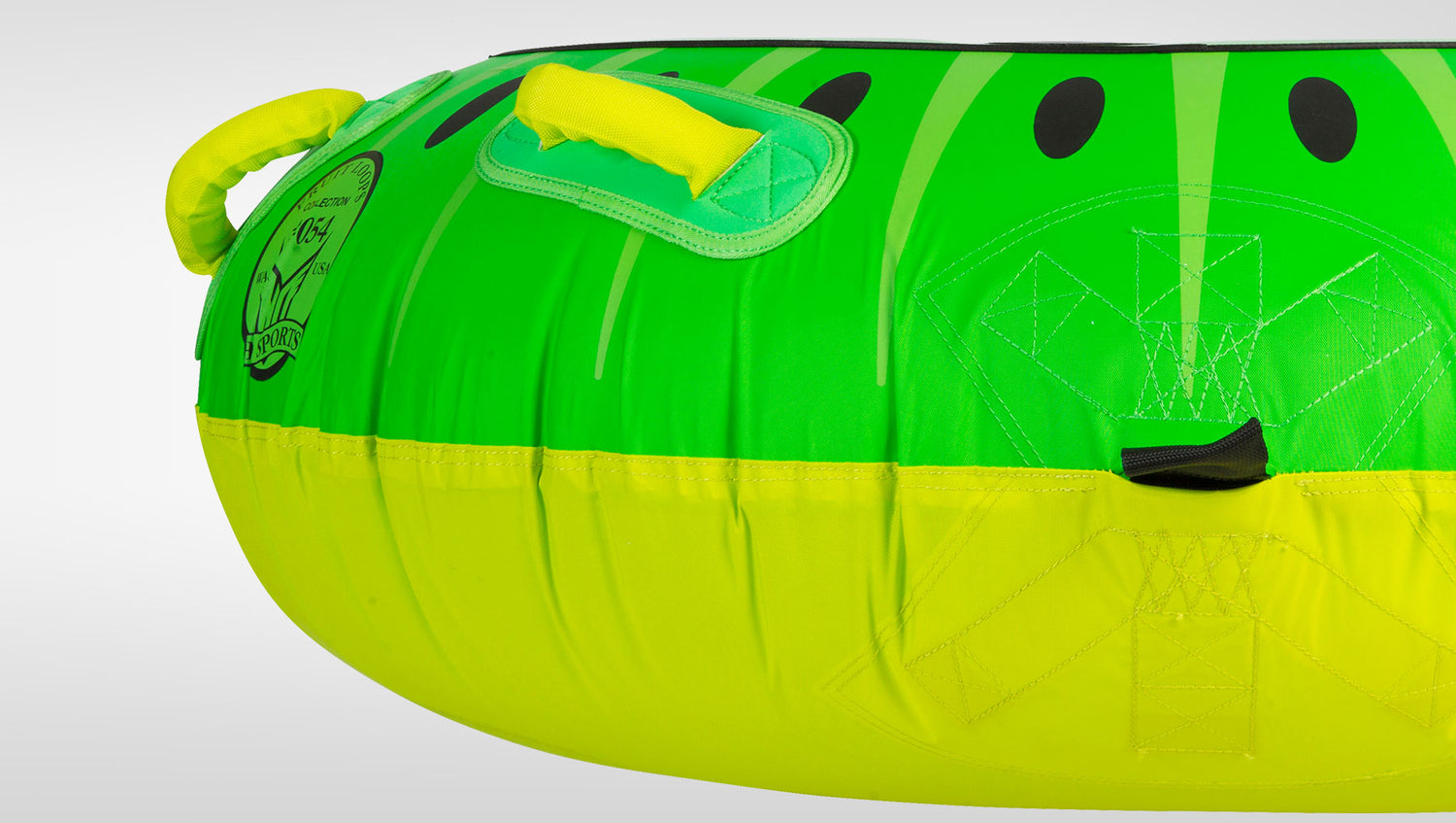 Close-up of Kiwi Tube's green and yellow kiwi-print surface with yellow padded handles and HO Sports logo.