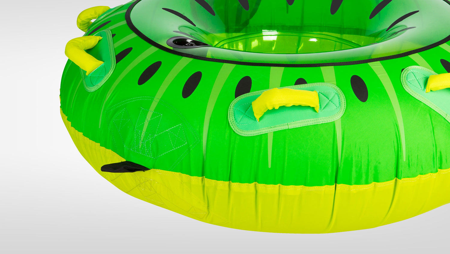 Angled view of Kiwi Tube's green kiwi-print surface with multiple yellow padded handles and clear bottom.