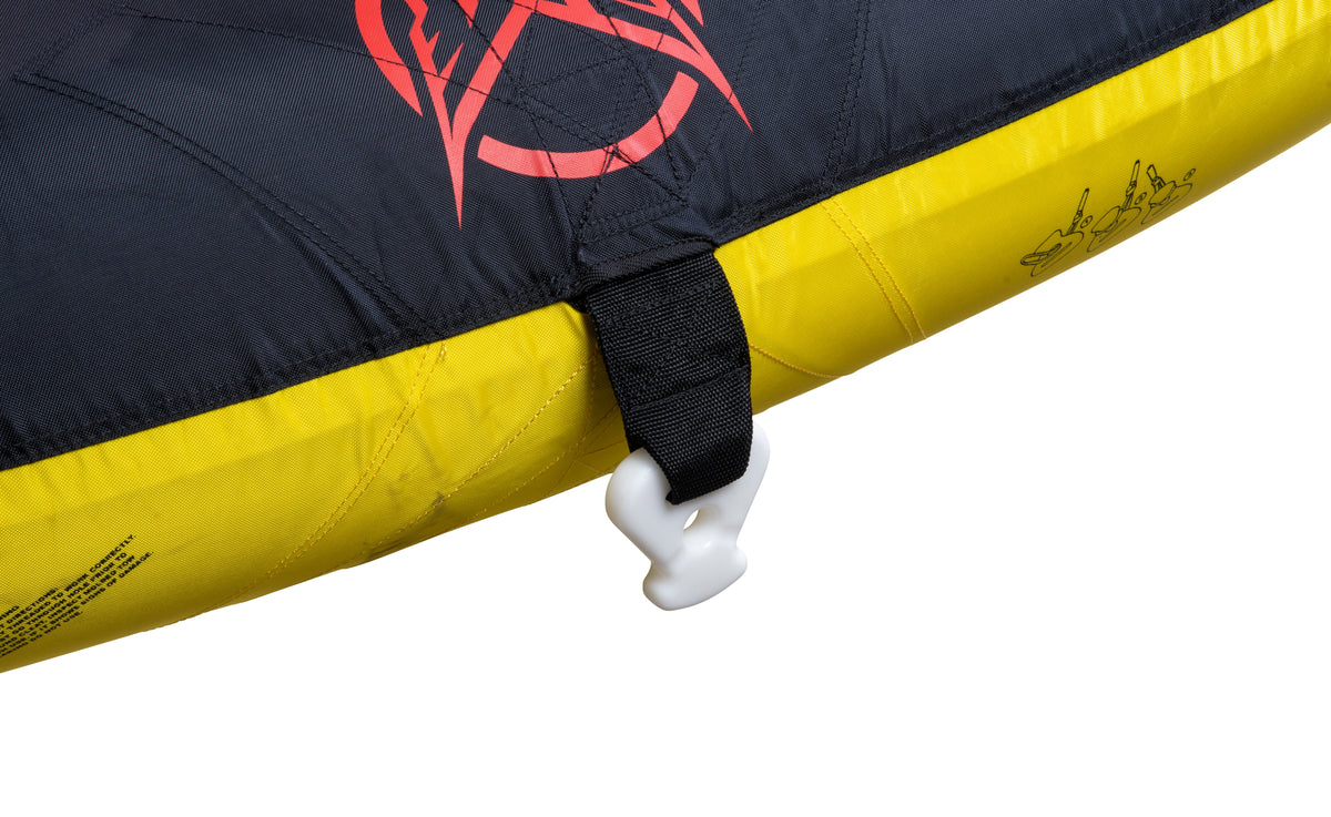 Close-up of Nova 4 tube's black and yellow surface with red graphic, black tow strap, and white connector clip.
