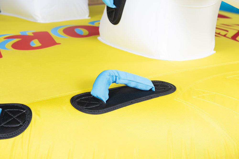 Close-up of Unicorn Tube's yellow surface with blue padded handle, black grip pad, and white unicorn head.