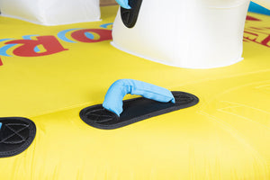 Close-up of Unicorn Tube's yellow surface with blue padded handle, black grip pad, and white unicorn head.
