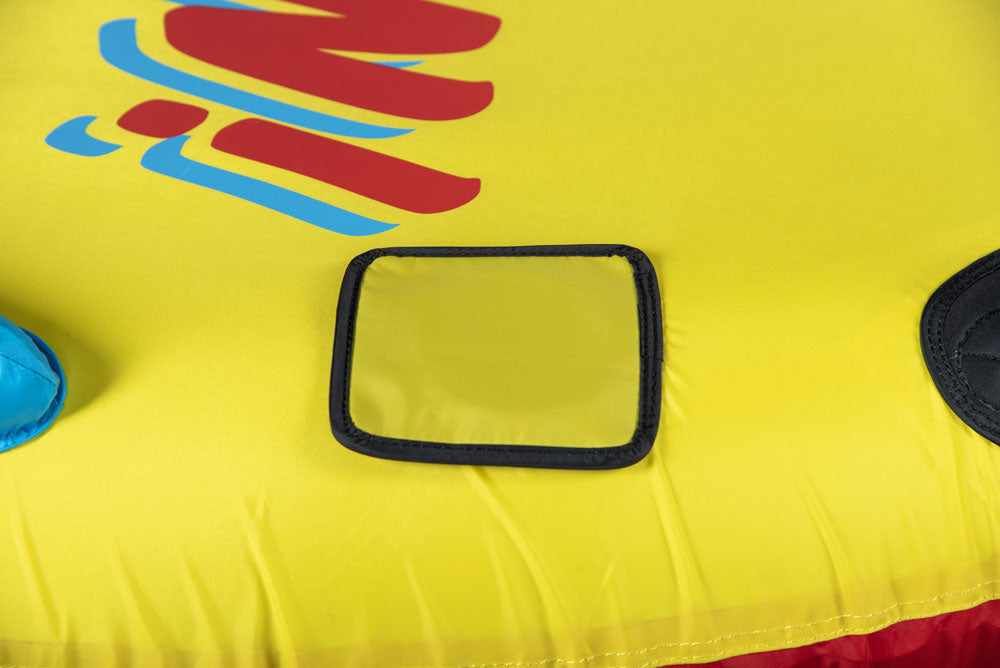 Close-up of Unicorn Tube's yellow surface with black rectangular handle grip and colorful branding.