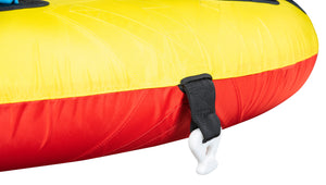 Close-up of Unicorn Tube's yellow and red surface with black tow strap and white connector clip.