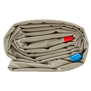Side view of the folded Play PAD mat, rolled up with red and blue inflation valves visible.