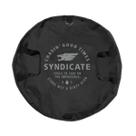 Top view of the black Syndicate Cinch Changing Mat, featuring a circular design, reinforced handles, and bold white logo.