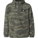 Front of the Syndicate Anorak in camo print, half-zip design, adjustable hood, and large front pocket with bold lettering.