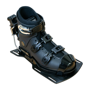 Angled view of the Syndicate Hardshell Demo Program boot with a black shell, metal buckles, and rear release.