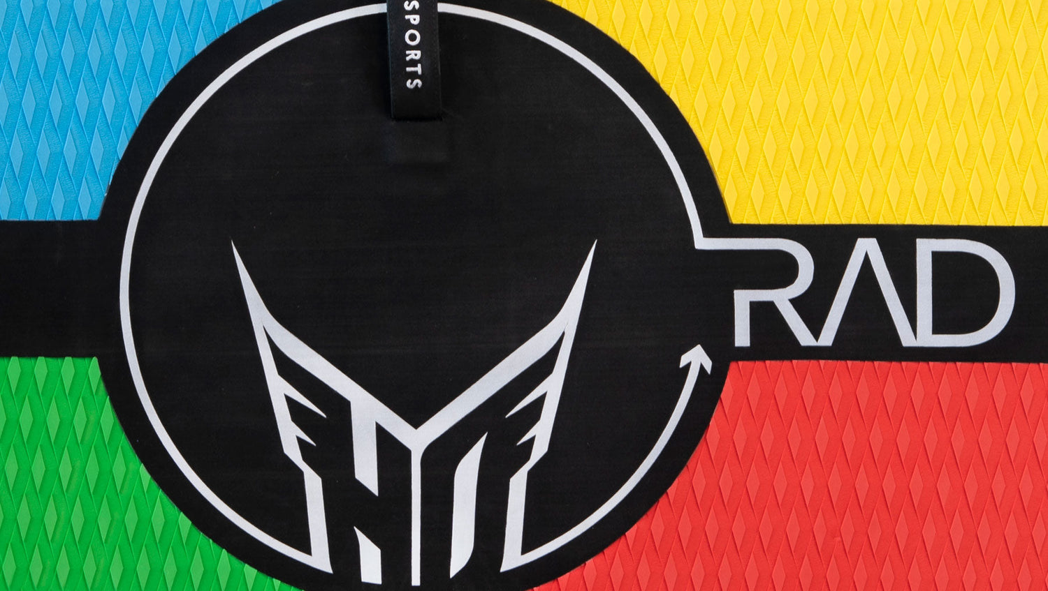 Close-up of RAD 5 kneeboard's multicolor surface with black center circle, HO Sports logo, and RAD branding.