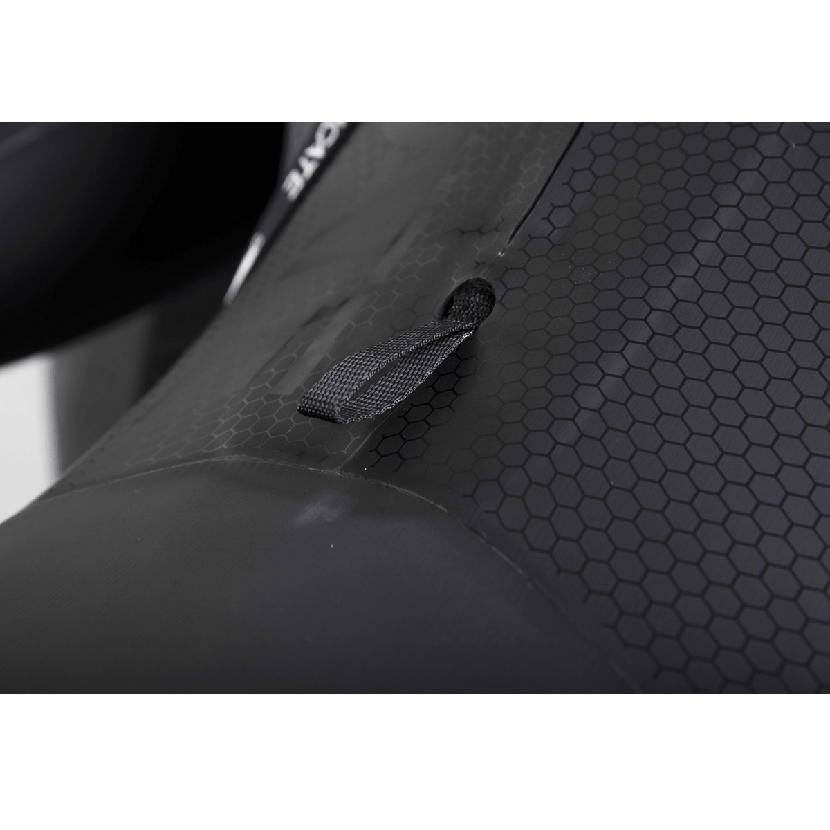 Close-up of the wetsuit’s hex-textured panel, featuring a reinforced pull tab for secure adjustments and enhanced durability.
