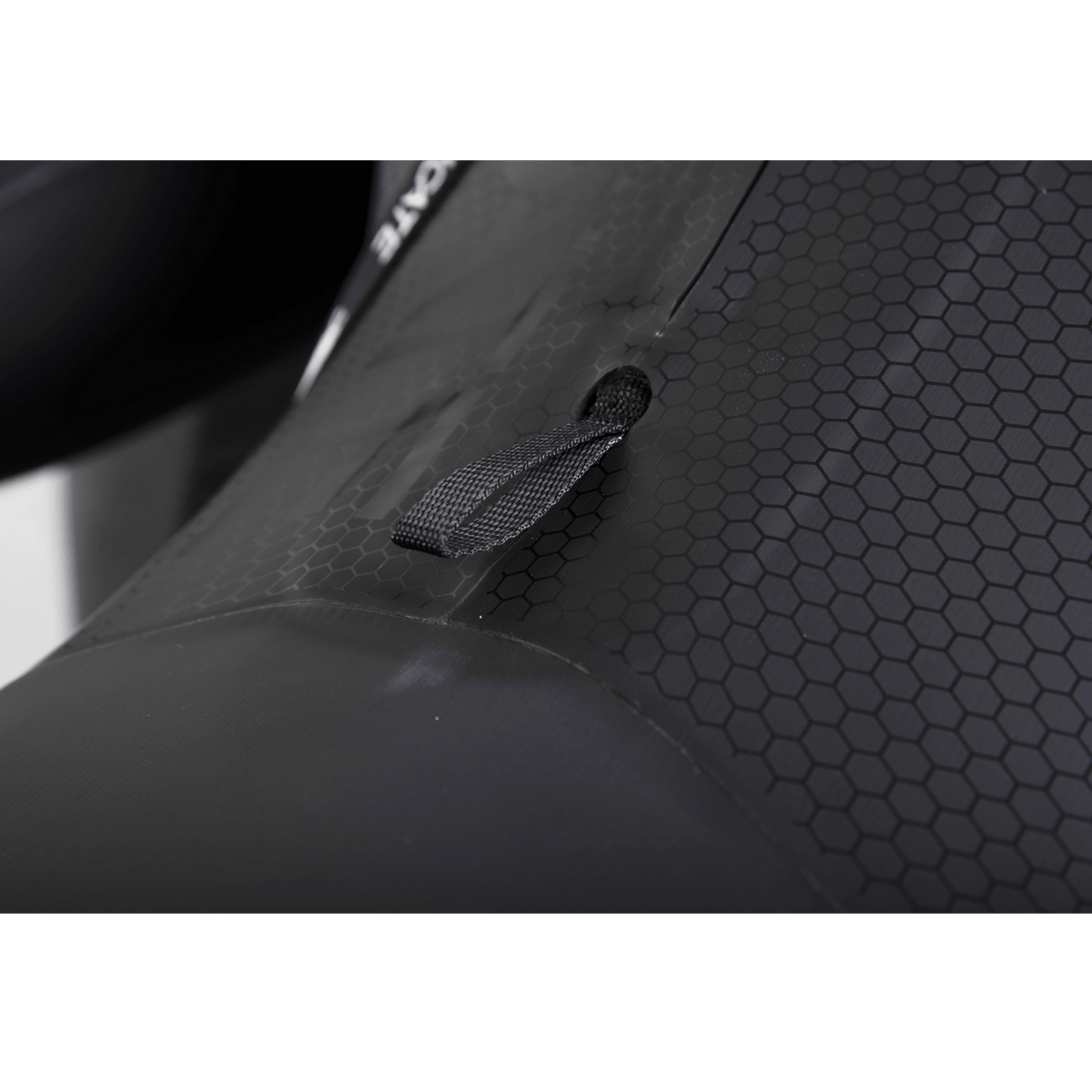 Close-up of the Syndicate Fullsuit's hex-textured back panel and black webbing pull loop.