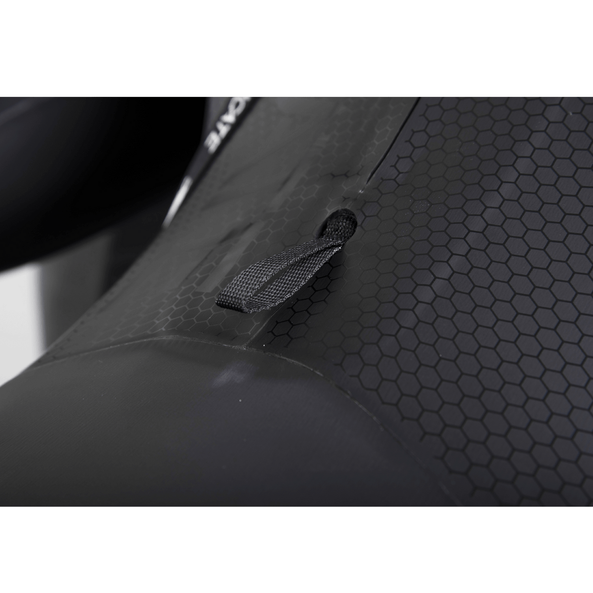 Close-up of the Syndicate LS Spring Suit's hex-textured back panel and black webbing pull loop.