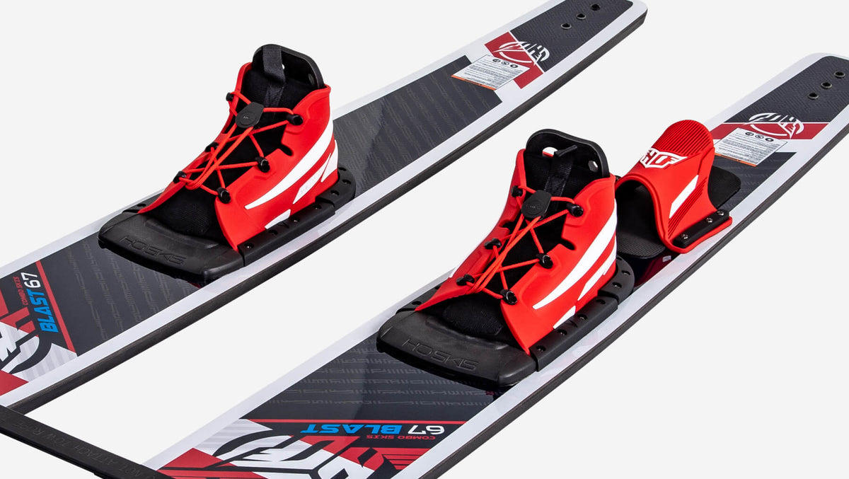 Red, black and white water ski bindings attached to waterskis on a white background