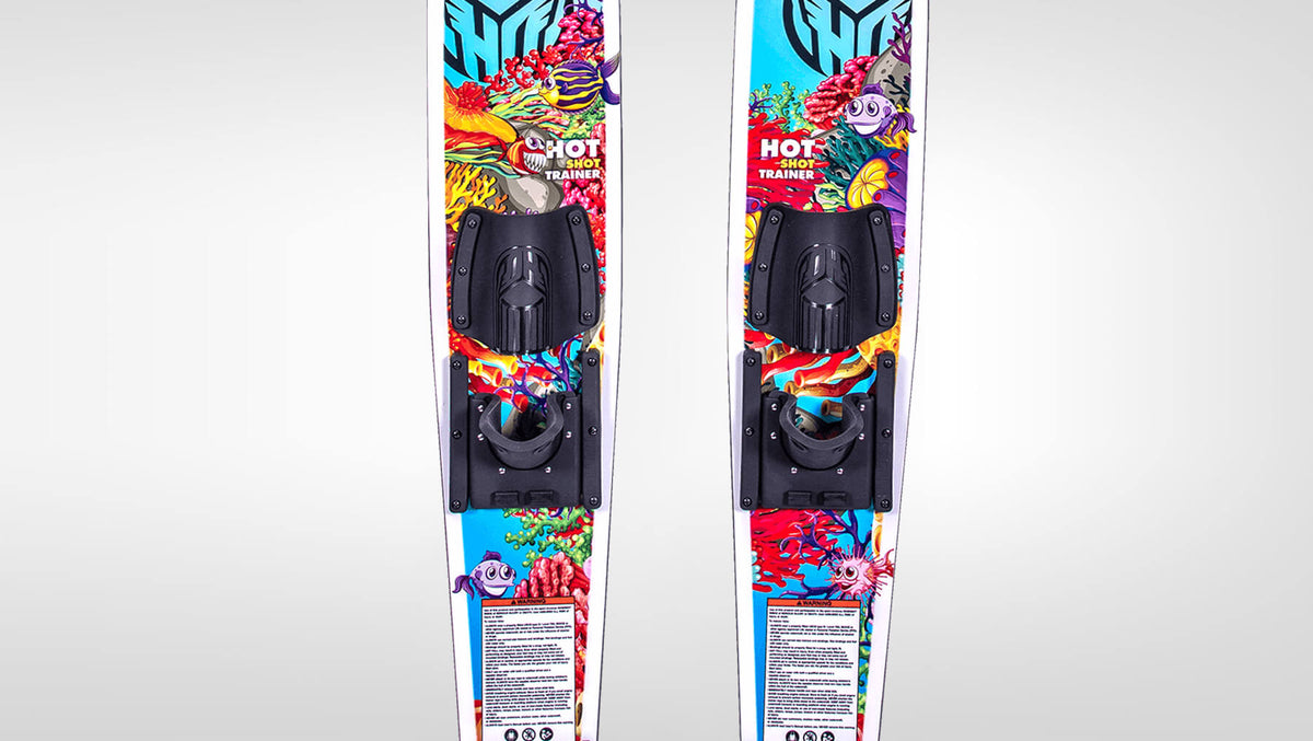 Top view of the hotshot trainer water skis with black bindings and cartoon fish / reef graphics on the top sheet.