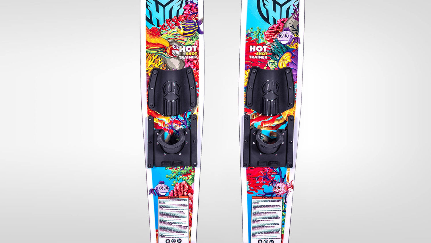 Top view of the hotshot trainer water skis with black bindings and cartoon fish / reef graphics on the top sheet.
